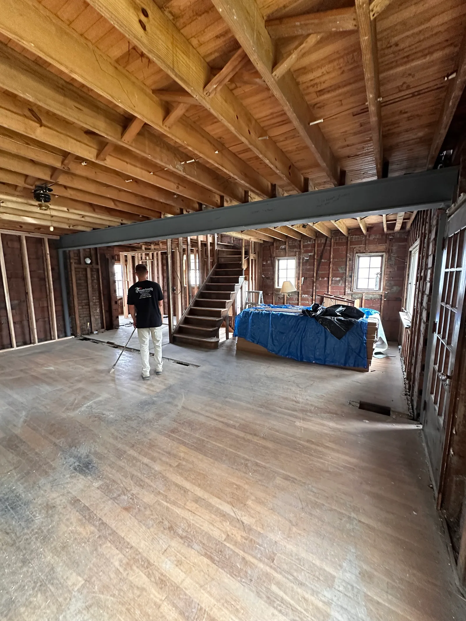 Completed steel beam installation spanning interior space with exposed framing