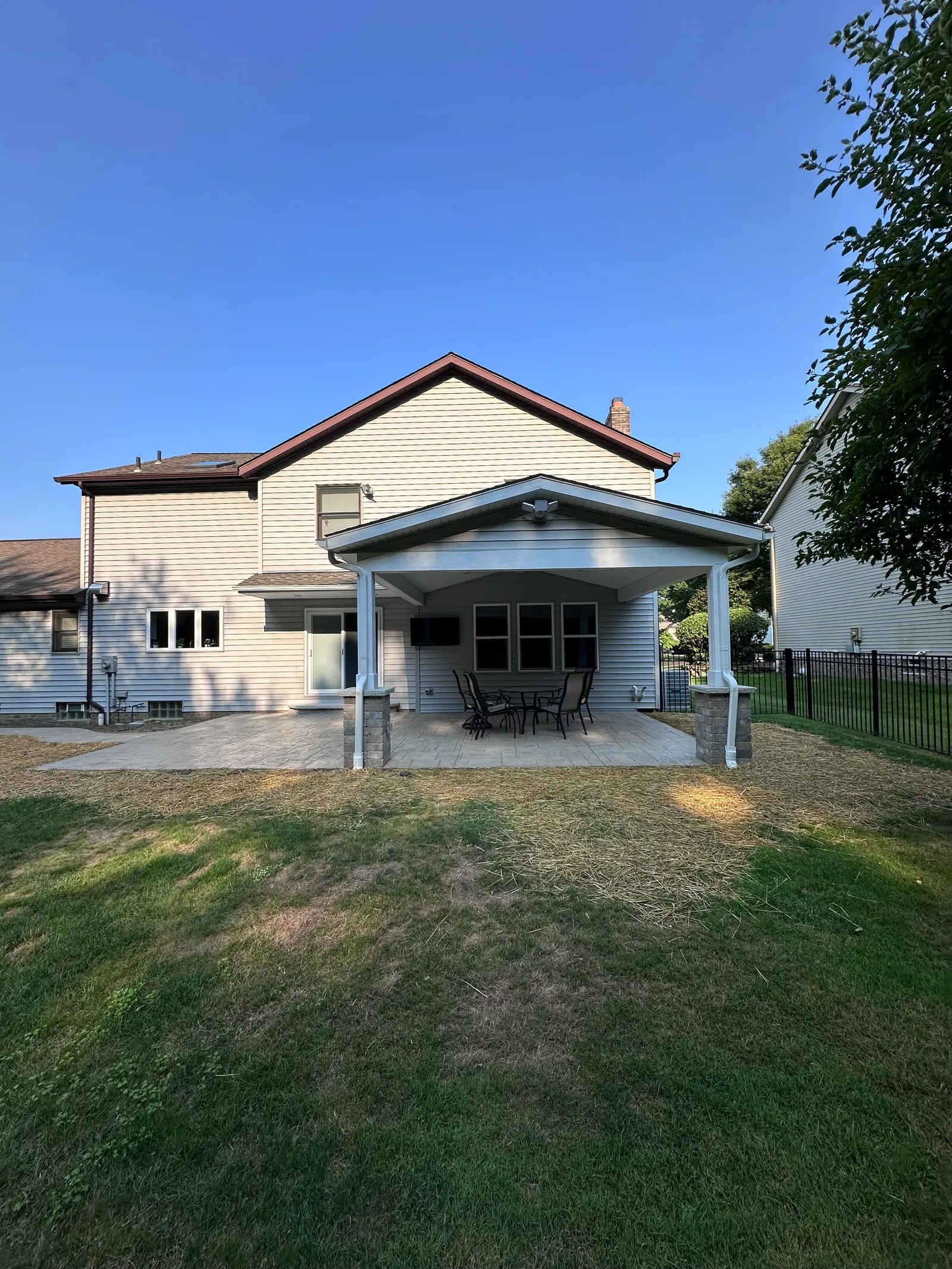 Completed covered porch addition with structural columns — finished result